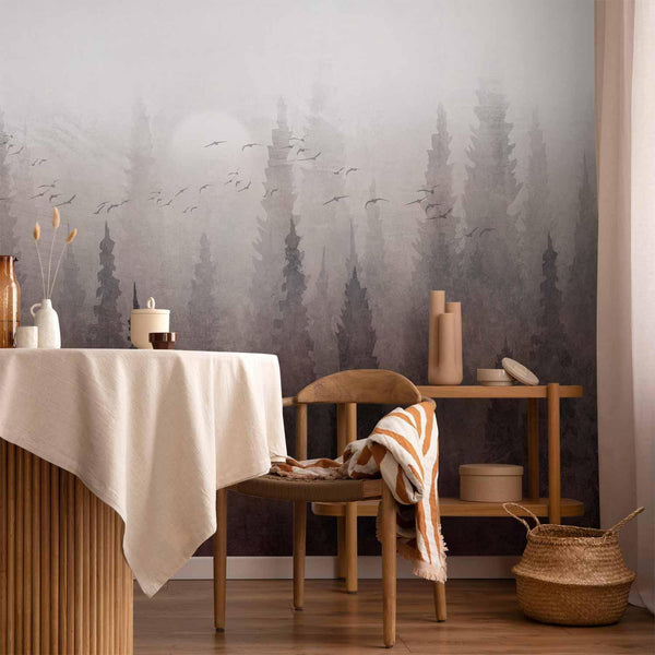 Wall Mural - Bird's flight over treetops - landscape of a dark forest in fog